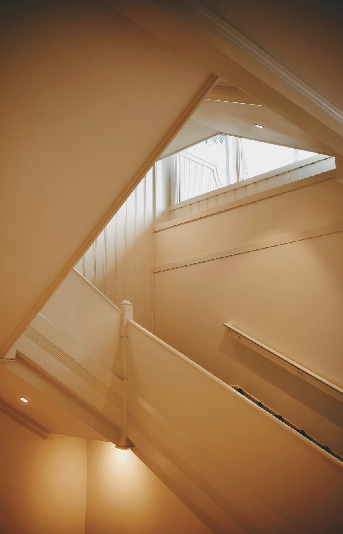 Sunlit interior staircase with warm natural light